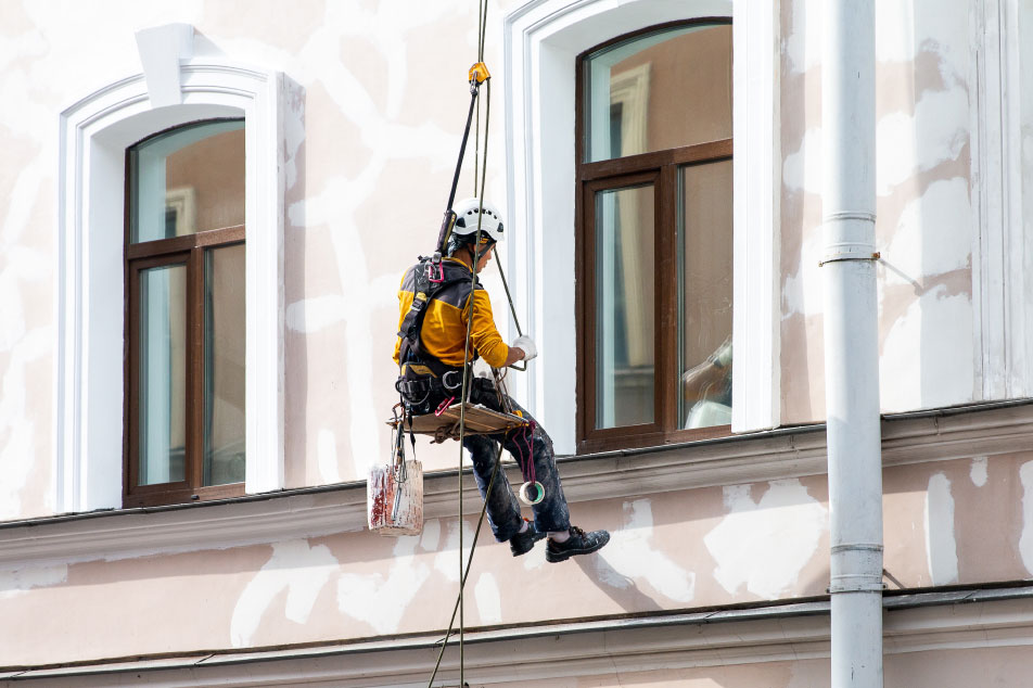 Plasterer working on the outside of a building