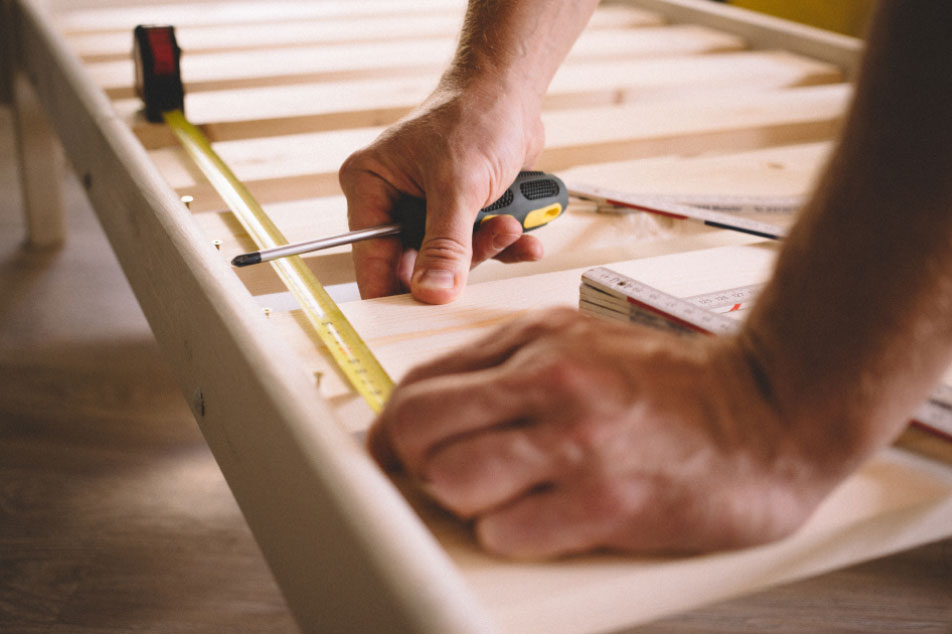 Carpenter measuring some wood